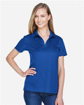 Devon & Jones DG20W Women's CrownLux Performance Plaited Polo - True Royal - model front