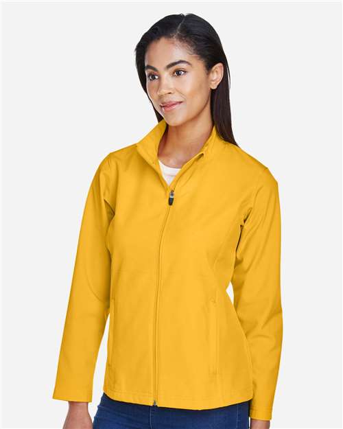 Team 365 TT80W Women's Leader Soft Shell Jacket - Sport Athletic Gold - model side