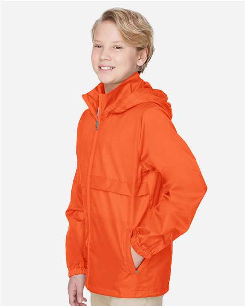 Team 365 TT73Y Youth Zone Protect Lightweight Jacket - Sport Orange - model side