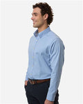 Devon & Jones DG505 Men's CrownLux Performance Spencer Poplin Dress Shirt - Light Blue Melange - model side